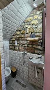 a stone bathroom with a sink and a toilet at Anderr stone Boutique in Gjirokastër +19 photos