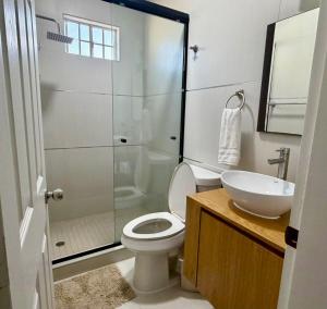 a bathroom with a shower and a toilet and a sink at Casa Costa Hermosa in Tijuana