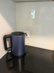 a blue mug sitting on top of a counter at Bern Garden Residence 152m Luxury Apartment in Bern +16 photos