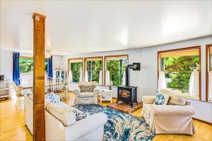 a living room with white furniture and a fireplace at Cozy Copalis Beach Cottage Escape in Copalis Beach +44 photos