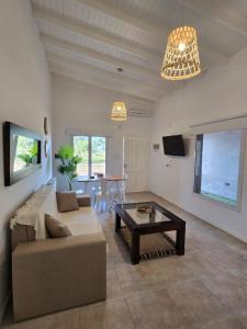 a living room with a couch and a table at Casita Cómoda y Acogedora in Trenque Lauquen