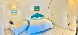 a bedroom with a bed and a chair in it at Santiago vacation home in Positano in Positano