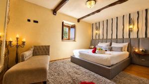a bedroom with a bed and a couch in a room at Casa Love Story - Piscina, Sauna & Jacuzzi in Arcos de Valdevez