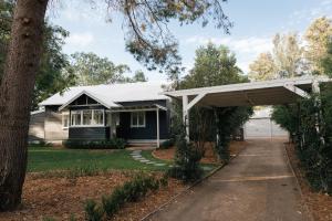 a house with a garage and a driveway at The Foxman Cottage in Broke