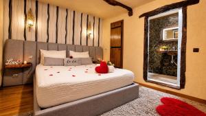 a bedroom with a bed with a red pillow on it at Casa Love Story - Piscina, Sauna & Jacuzzi in Arcos de Valdevez
