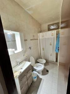a bathroom with a toilet and a sink and a shower at Casa Bella Vista in Pocito