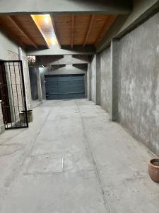 an empty garage with a blue garage door at Casa Bella Vista in Pocito