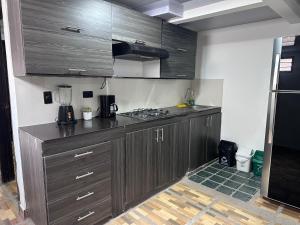 a kitchen with dark wood cabinets and a blender at donde la abuela Josefa in Quimbaya +4 photos