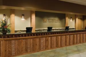 a lobby of a hotel with a counter with computers on it at Club Wyndham Great Smokies Lodge in Sevierville +103 photos