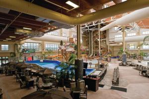 a large building with a pool and tables and chairs at Club Wyndham Great Smokies Lodge in Sevierville