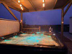 a hot tub in a backyard at night at The Cottage in Ballaghaderreen