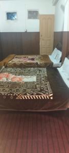 two beds sitting next to each other in a room at Hamala Inn Hotel in Abbottabad