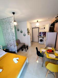 a kitchen and a living room with a table and chairs at Sole Di Mare Agia Triada in Agia Triada +18 photos
