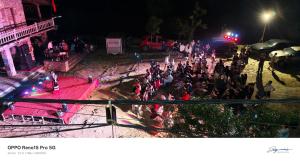 a crowd of people standing in the street at night at A THÁM homestay in Dam Thuy