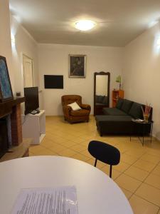 a living room with a couch and a chair at Holidays House Il Vicoletto in Sulmona