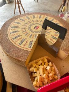 a cheese wheel on a table with a cheese at Bois-raiguel chasseral in Corgémont +18 photos