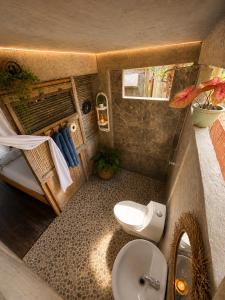 a small bathroom with a toilet and a sink at El cielo hotel isla fuerte in Puerto Limón