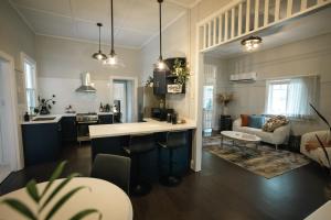 a kitchen and living room with a couch and a table at The Foxman Cottage in Broke