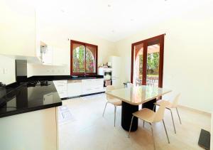 a kitchen with a table and chairs in it at Luxury villa in Azib Oulad Lâdem