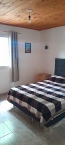 a bedroom with a black and white checkered bed at Los Abuelos in Potrero de Garay