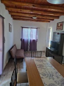 a living room with a dining room table and a couch at Los Abuelos in Potrero de Garay