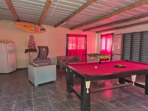a room with a ping pong table in a room at Los Abuelos in Potrero de Garay