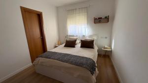 a bedroom with a bed with two pillows and a window at בית נעים בין המדבר לים in Eilat