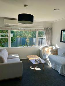 a living room with a couch and a coffee table at Sunbeam Cottage in Havelock North
