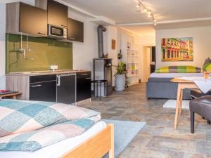 a room with a kitchen and a living room at Klein Hintermühltalhof in Itter +14 photos