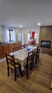 a dining room with a table and chairs and a kitchen at Casa Do Olival in São João da Pesqueira