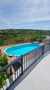a swimming pool on a balcony with a fence at Casa Do Olival in São João da Pesqueira +15 photos