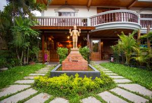 a statue in the courtyard of a house at Hima Boutique in Siem Reap
