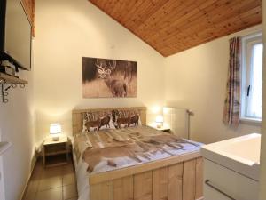 a bedroom with a bed with two deer on it at Coeur de Biche in Rendeux