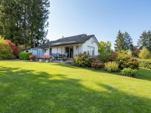 a white house with a lawn in front of it at Coeur de Biche in Rendeux