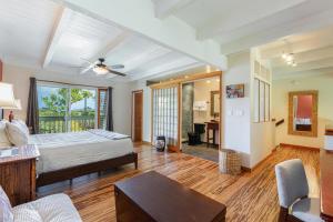 a bedroom with a bed and a living room at Puamana 19C in Princeville +14 photos