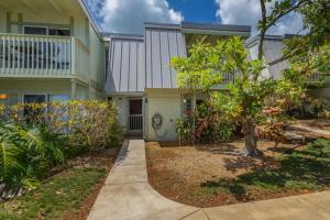 a house with a walkway in front of it at Puamana 19C in Princeville