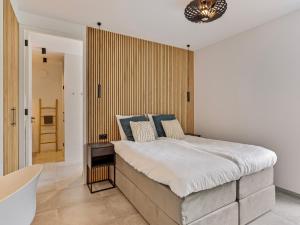 a bedroom with a large bed in a room at Het Duinnest in Kamperland