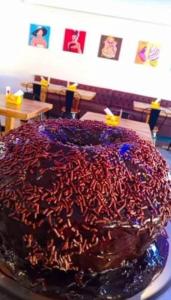 a chocolate cake with red sprinkles on a plate at Pousada Quixadá Confort in Quixadá