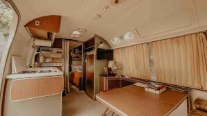 a kitchen with a wooden table in a trailer at Urban Airstream Retreat in Memphis