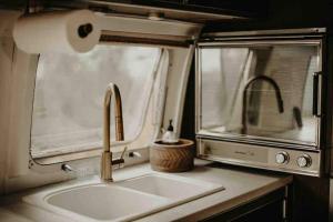 a kitchen with a sink and a window at Urban Airstream Retreat in Memphis +26 photos