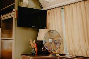 a fan sitting on a table next to a window at Urban Airstream Retreat in Memphis