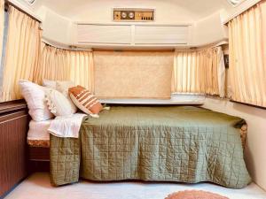 a small bedroom with a bed in an rv at Urban Airstream Retreat in Memphis