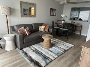 a living room with a couch and a table at Surfer's Bungalow in San Diego