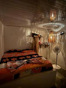 a bedroom with a bed and a lamp in it at Isla fuerte House in Puerto Limón