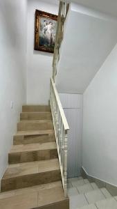 a stairway with a painting on the wall and a picture at Casa Costa Hermosa in Tijuana