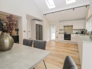 a kitchen and dining room with a table and chairs at Cross Winds in Lancaster +52 photos