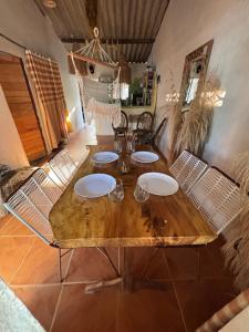 a wooden table and chairs in a room at Isla fuerte House in Puerto Limón