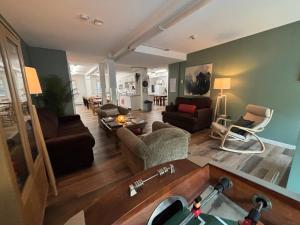 a large living room with a couch and chairs at Jasper East Hostel - Near Jasper National Park East Gate Entrance in Jasper