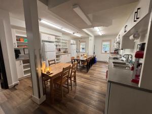 a kitchen and dining room with a table and chairs at Jasper East Hostel - Near Jasper National Park East Gate Entrance in Jasper