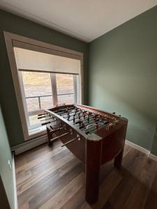 a large foos ball in a room with a window at Jasper East Hostel - Near Jasper National Park East Gate Entrance in Jasper +36 photos